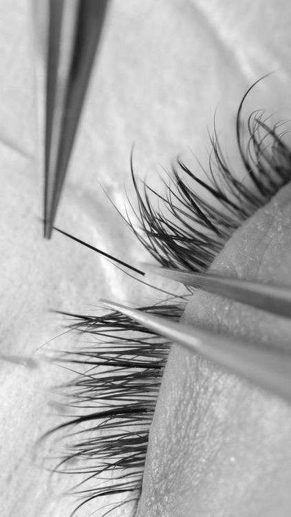 Close-up of lash extensions being carefully applied
